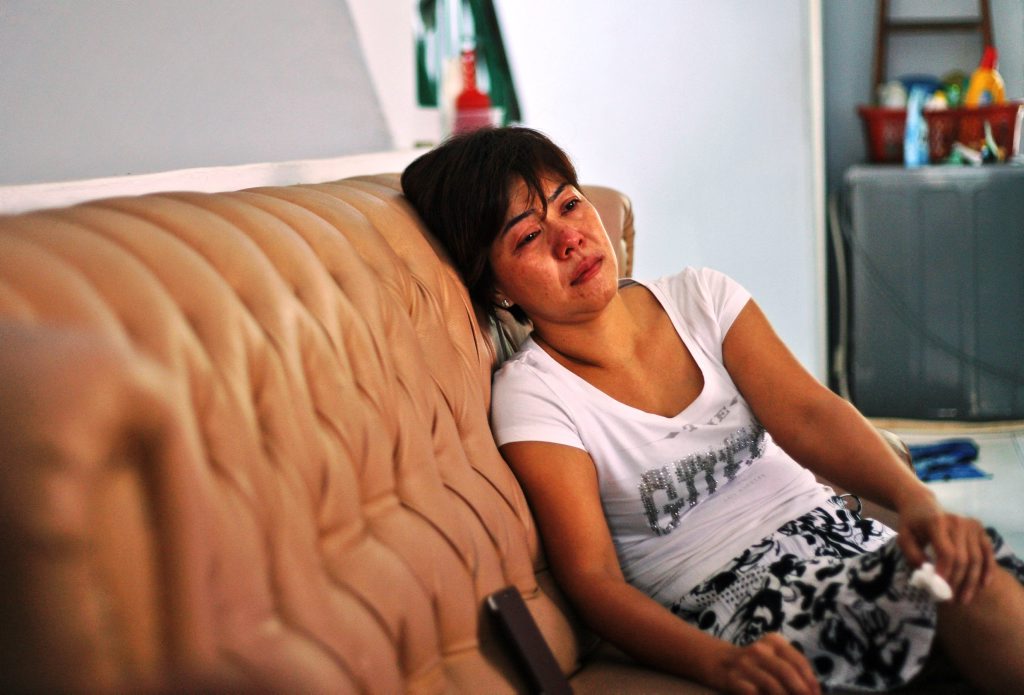 Yenny, the sister of Sugianto Lo who was onboard the Malaysia Airlines plane MH370, weeps on the couch as she watches news update on the search of the wreckage of the jetliner at their family residence in Medan, North Sumatra, Indonesia, Tuesday, March 25, 2014. After 17 days of desperation and doubt over the missing Malaysia Airlines jet, the country's officials said an analysis of satellite data points to a Yenny, the sister of Sugianto Lo who was onboard the Malaysia Airlines plane MH370, weeps on the couch as she watches news update on the search of the wreckage of the jetliner at their family residence in Medan, North Sumatra, Indonesia, Tuesday, March 25, 2014. After 17 days of desperation and doubt over the missing Malaysia Airlines jet, the country's officials said an analysis of satellite data points to a